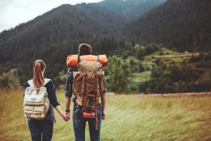 Man Traveler with backpack relaxing outdoor